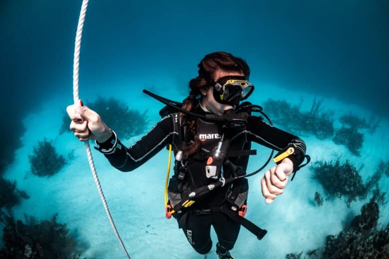 small / SSI certified diver descending on a rope during a guided dive in Bonaire